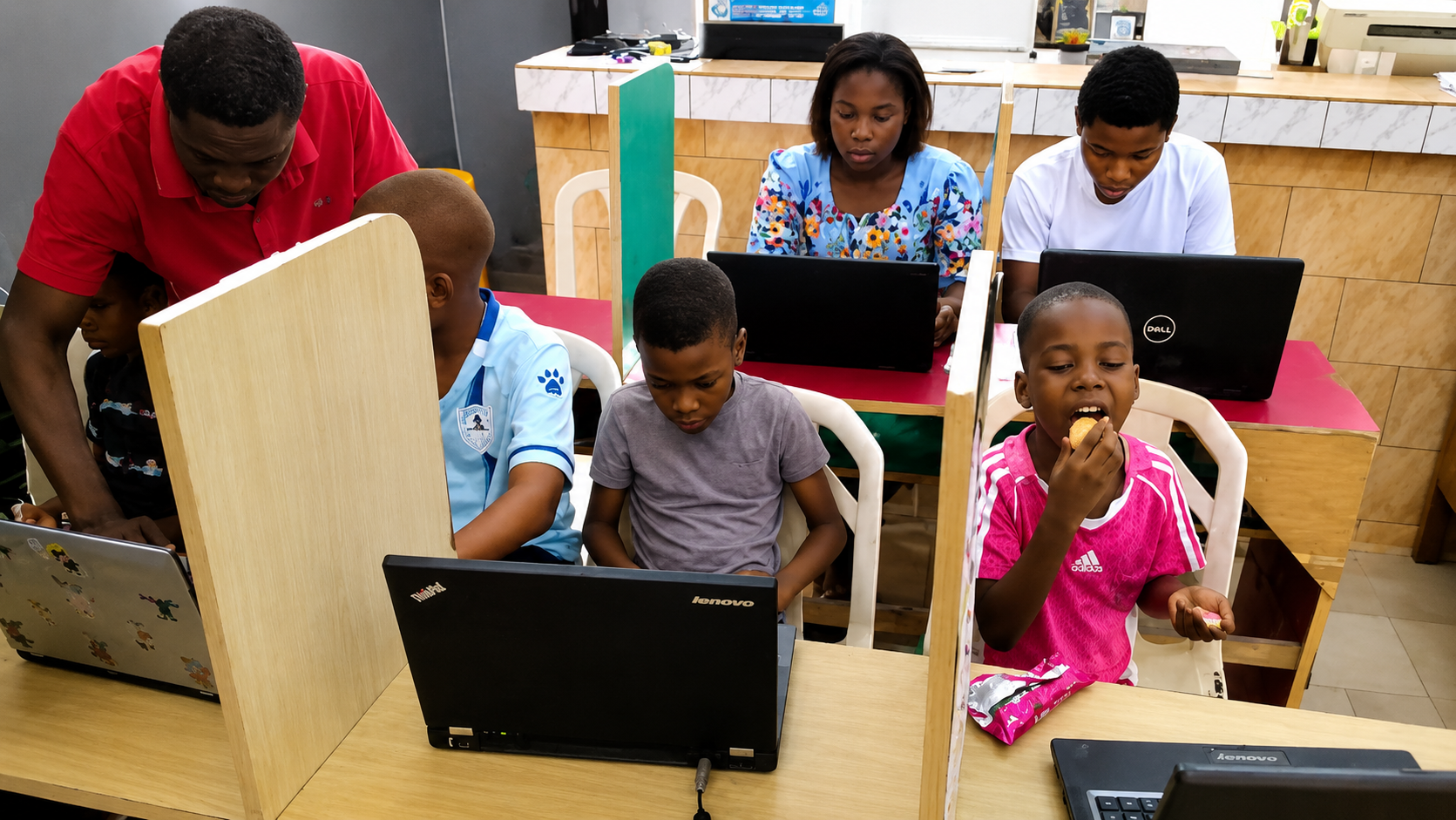 JENECONK AI Academy learners practising with laptops during a live bootcamp